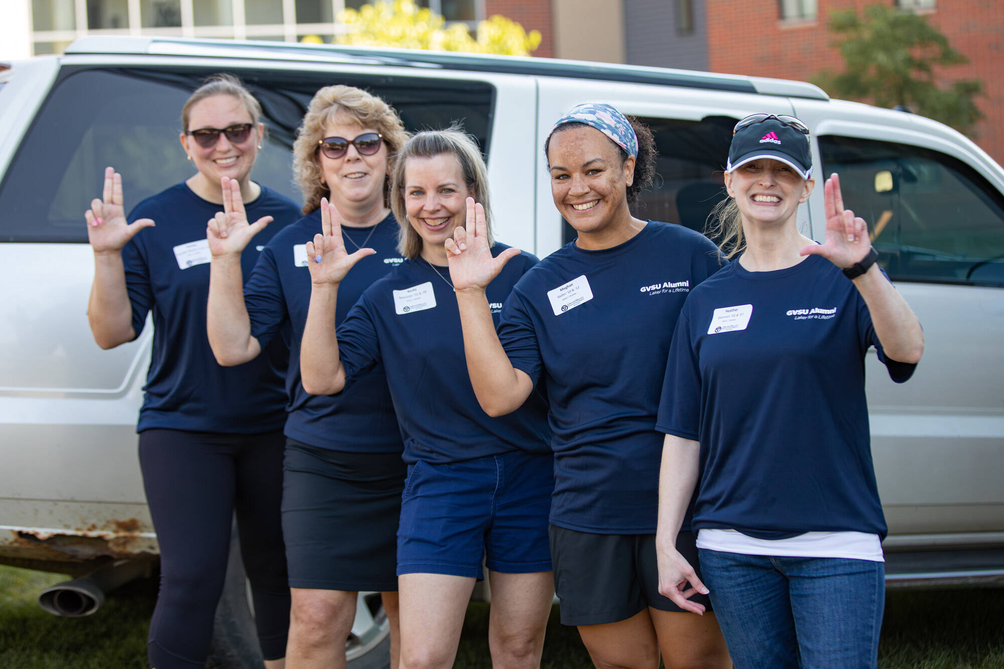 Five women outside in Alumni volunteer t-shirts